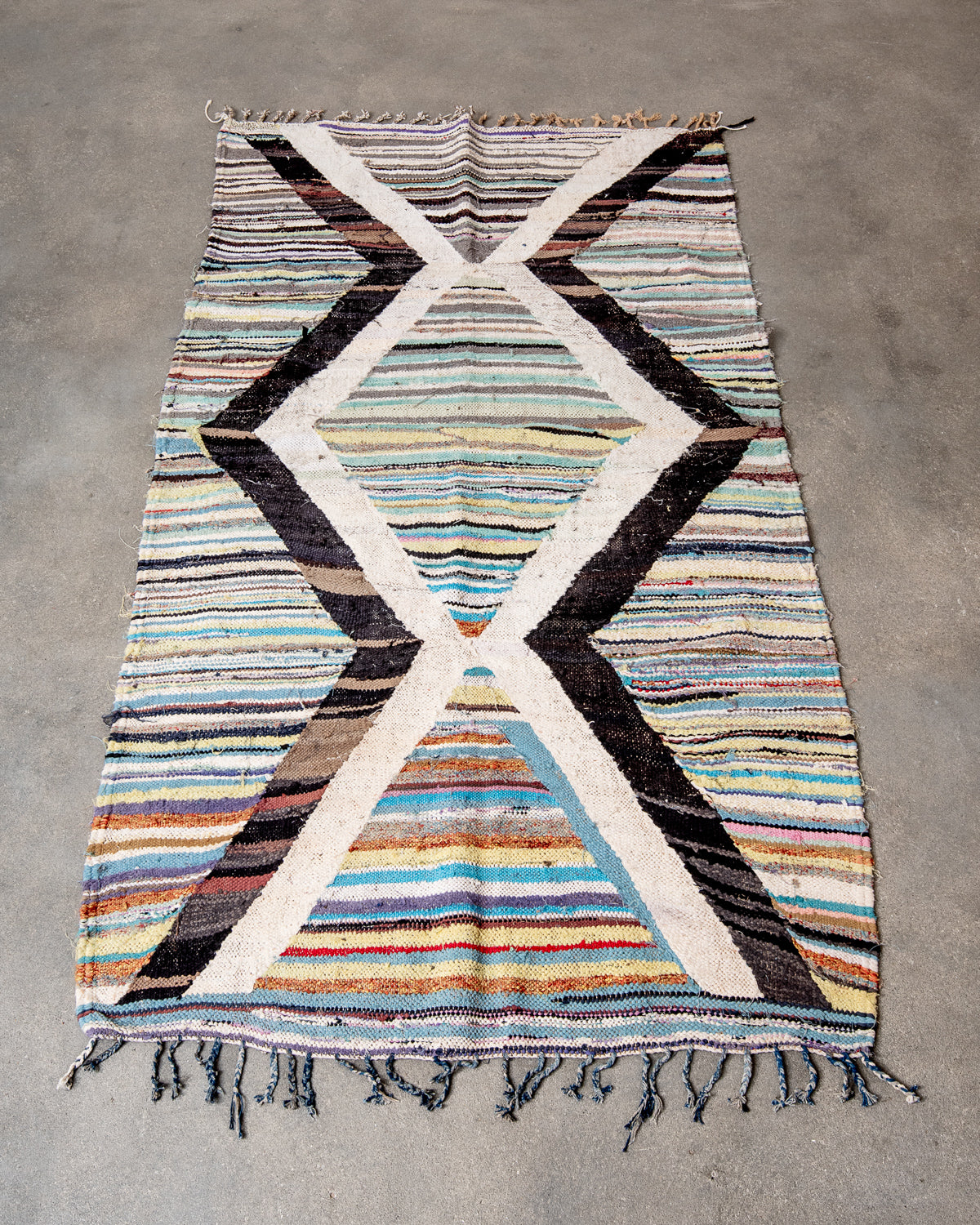 Modern designer vintage handcrafted Berber rug from Morocco. Boucherouite runner rug with beautiful colors and patterns.